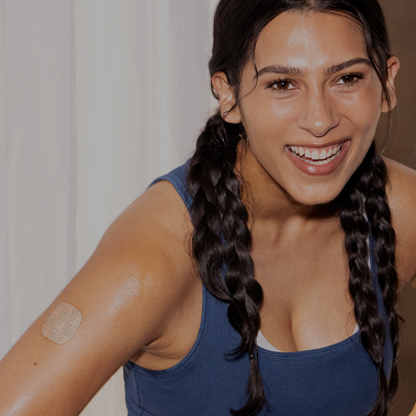 Woman wearing a birth control patch on her upper arm
