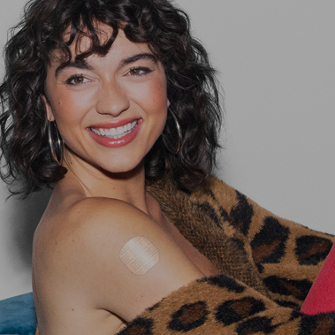 Woman wearing a birth control patch on her upper arm